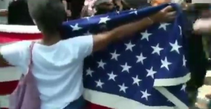Watch: Older woman holding American flag hit, dragged in Boston
