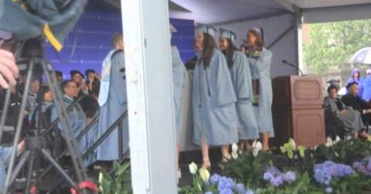 Columbia U. mattress girl carries her mattress onstage at graduation