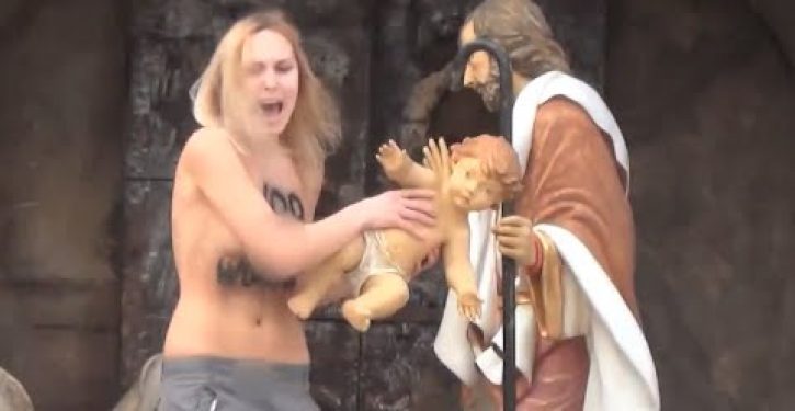 Topless member of militant feminist group steals Baby Jesus from Vatican nativity display (Video)