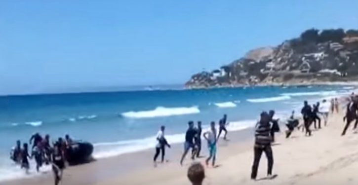 Migrants on dinghy evade border guard, storm popular tourist beach in Spain