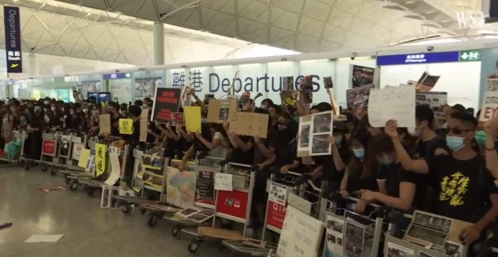 Police, protesters clash at Hong Kong airport; China moves military forces near border