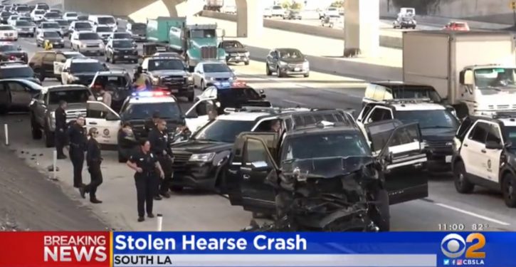 Stolen hearse crashed on L.A. freeway in police chase; casket, body inside