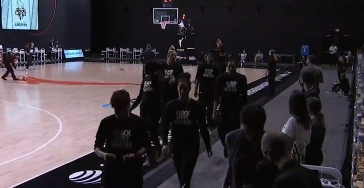 WNBA players walk off court during playing of national anthem