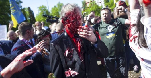 Protesters douse Russian ambassador with red paint by LU Staff