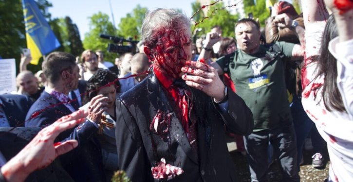Protesters douse Russian ambassador with red paint