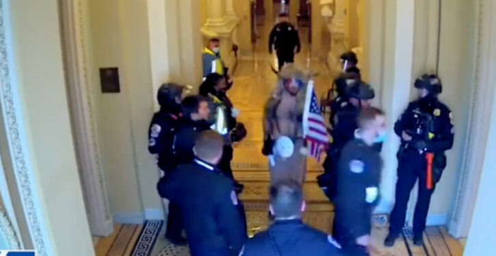 Previously Unseen Jan. 6 Footage Reveals Officers Apparently Leading QAnon Shaman Through Senate Halls